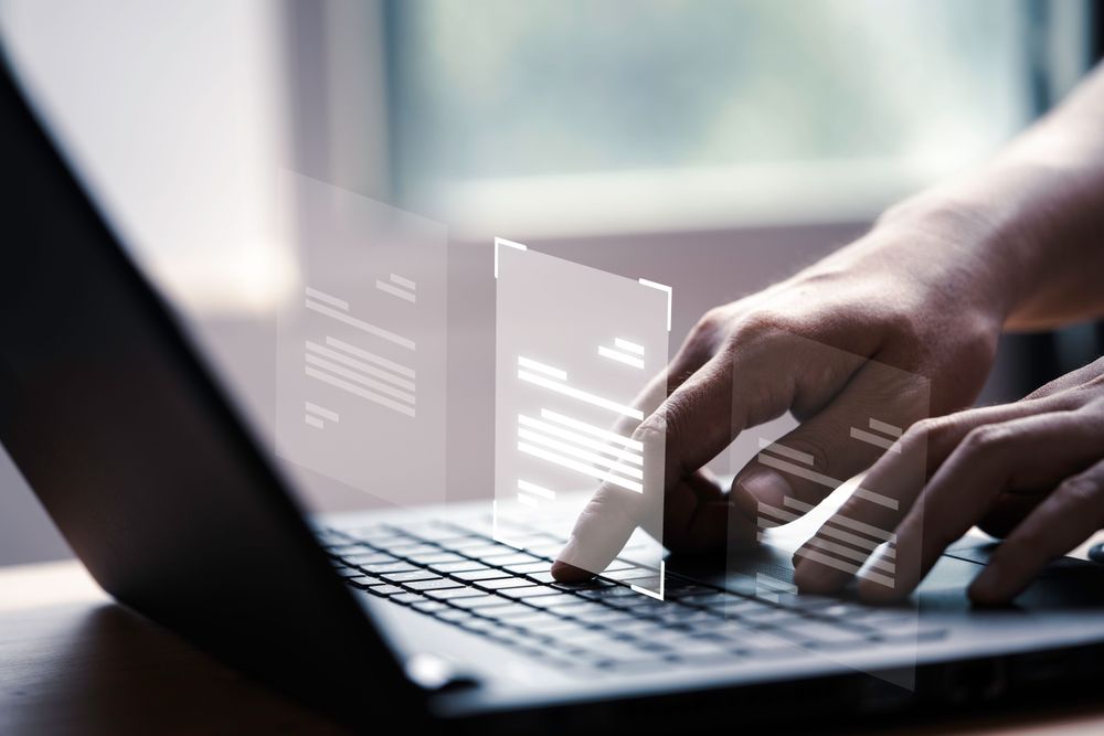 Hands typing on laptop keyboard
