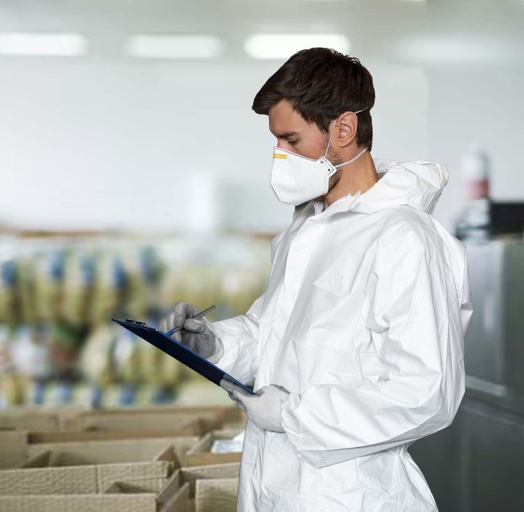 Person in lab coat reviewing clipboard