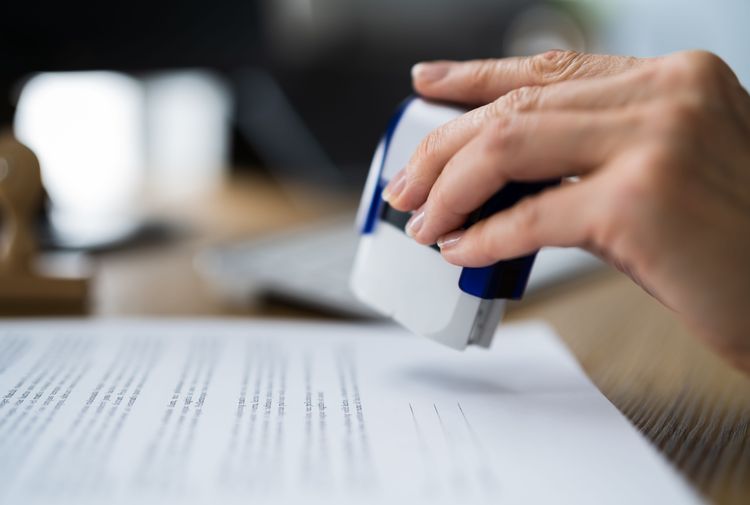 Hand stamping document with blue seal
